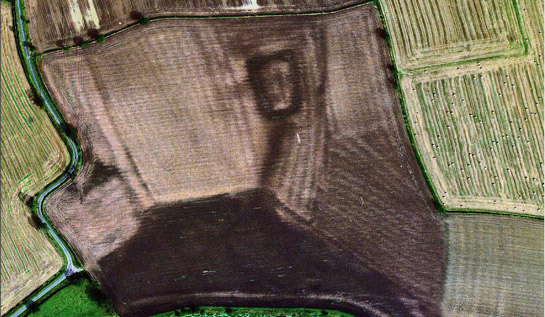   Figure 4: Woodhouse field moat in 1999 (dark rectangle at top middle of frame).  Ridge and furrow patterns and the dark outline of the moat are now visible as soil marks in this recently ploughed field