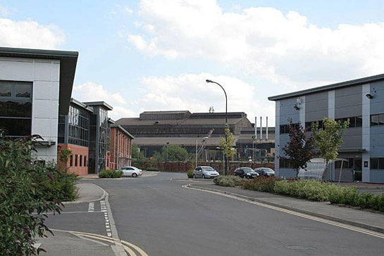 Text Box: Figure 1: ‘New and Old in Brightside’ – In the foreground are office buildings of ‘Jessop’s Riverside’ an early 21st Century commercial development of a former steelworks site. In this zone such developments typically sit alongside surviving industrial complexes. In the background are the Electric Arc Melting sheds of Sheffield Forgemasters